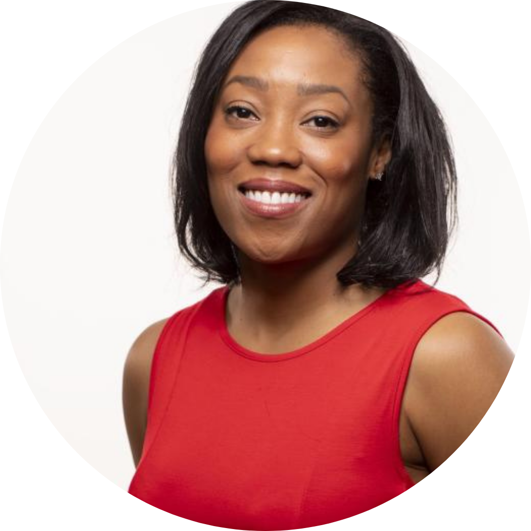 Photo of a black woman with a red shirt and straight hair cut to her shoulders smiling at the camera against a white background